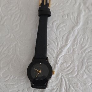 Movado Small Face Black and Gold watch
